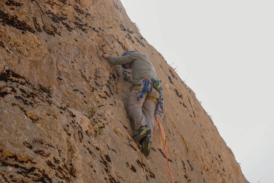 Climbing pitons on rugged rock face