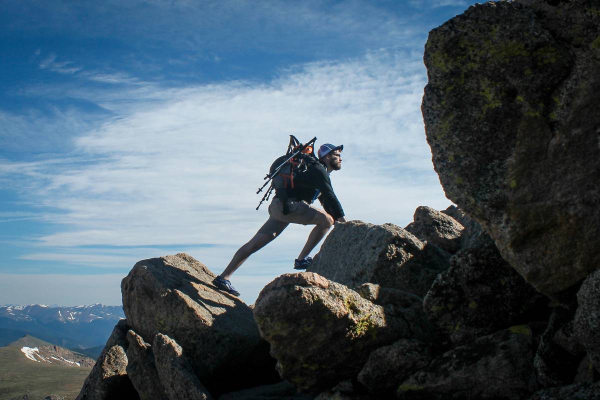 Climber placing a piton for flaring cracks in Yosemite granite wall